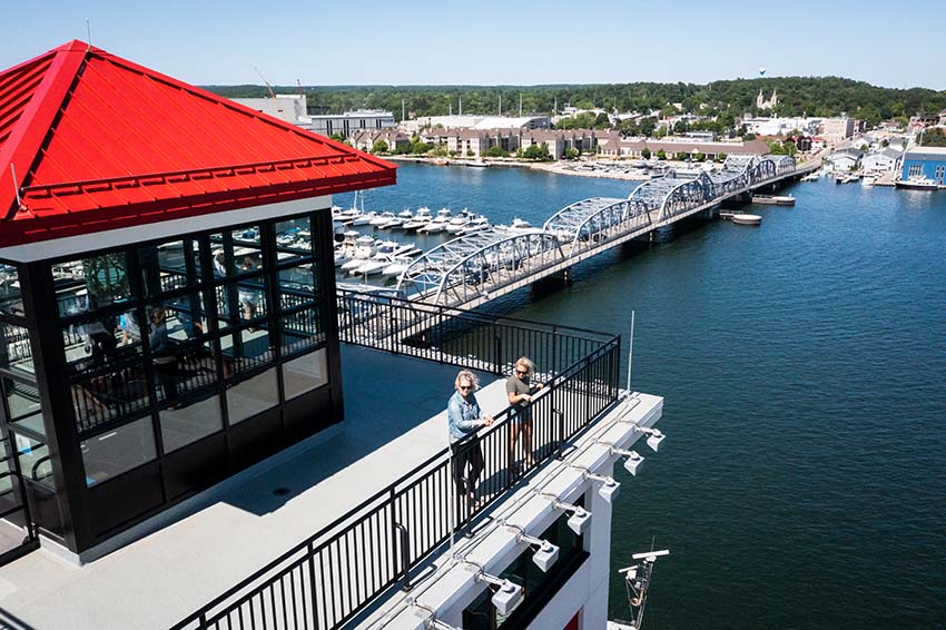 Two woman stand atop the Kress Tower and getting an aerial view of Sturgeon Bay.