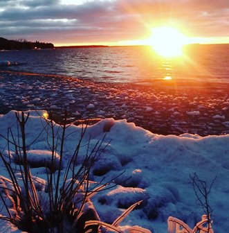 A sunrise over the frozen lake.