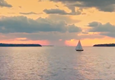 A sailboat out on the water on a cloudy day.