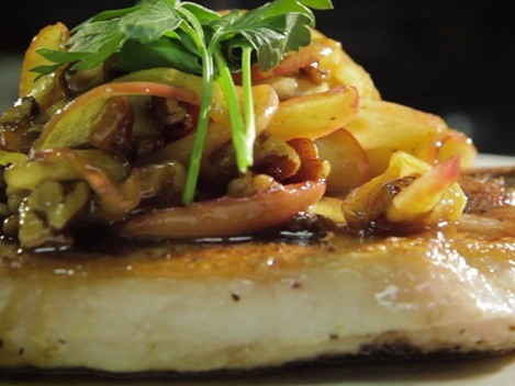 Close up of a pork chop with toppings