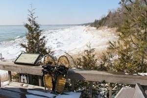 Snowshoes on a deck looking out at the lake