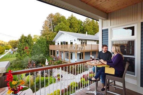 A couples dines on a patio overlooking downtown Fish Creek.