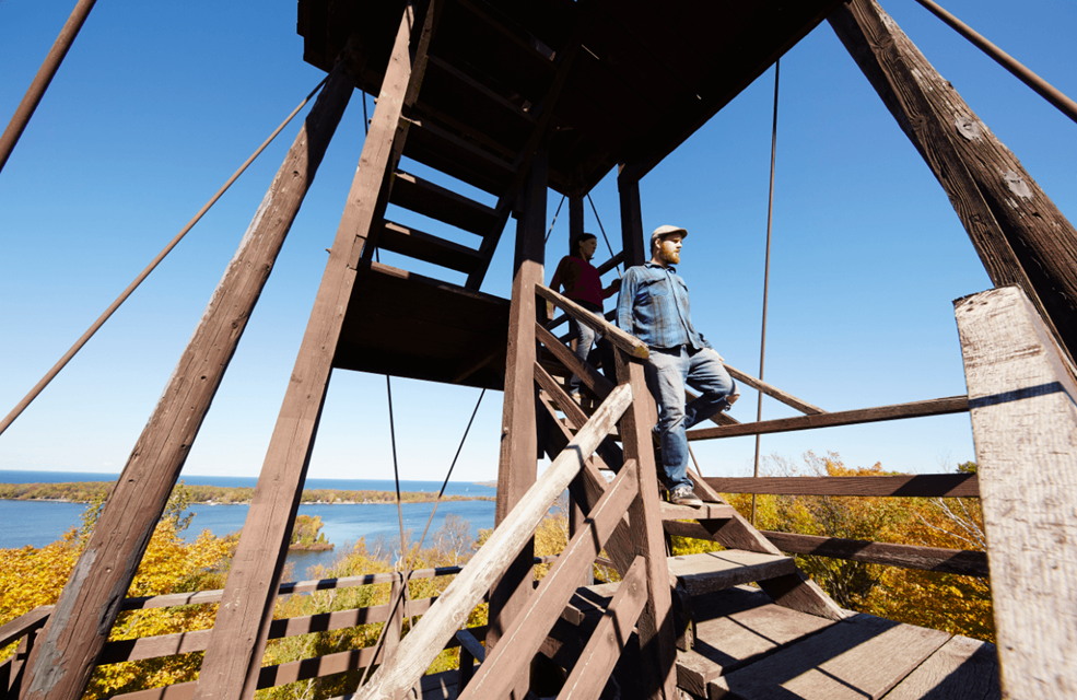A couple descending the stairs on a lookout tower at Potawatomi State Park.