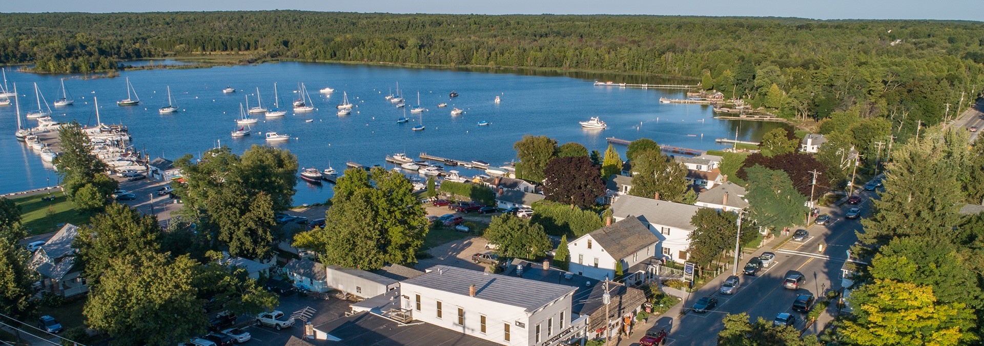 A town with many sailboats out on the lake from the air.