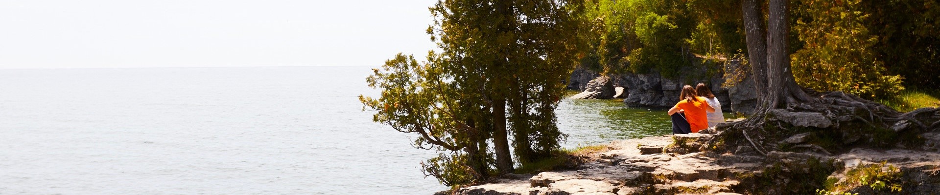 Couple sitting lakeside.