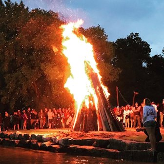 People watching a large bonfire.