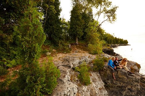 A couple and their dog taking a rest at Cave Point.