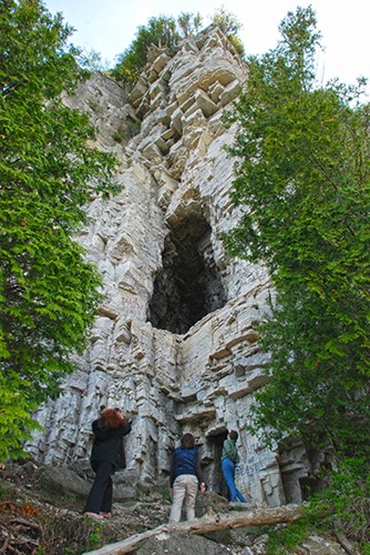 A view up a jagged cliffside with caves on Eagle Trail.