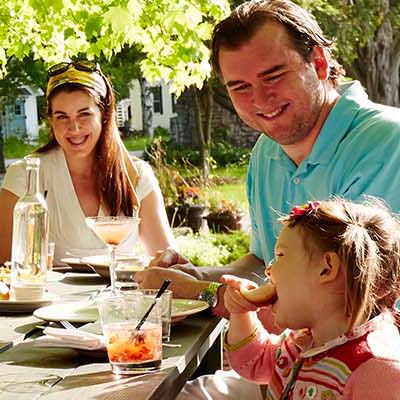 A family eating together at a picnic table