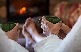 Closeup of people in robes sitting and holding teacups