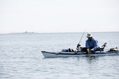 A person fishing off of a small boat