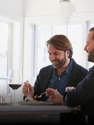 Couple enjoying an upscale meal with a glass of red wine