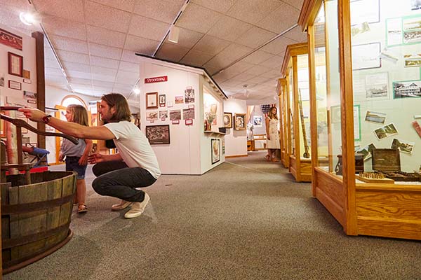 A father and daughter looking at an exhibit in a museum