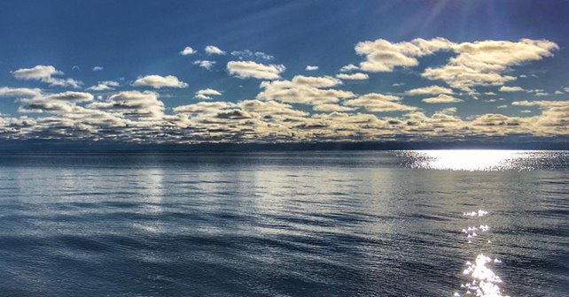 A cloudy blue sky reflecting over the lake