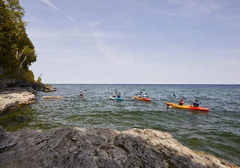 Kayakers paddling off shore.