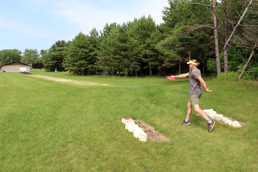 A person throwing a disc