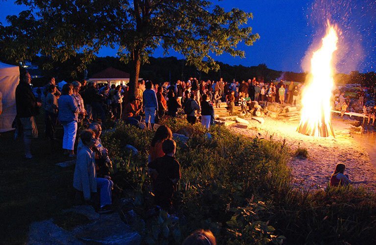 People around a large bonfire