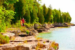 A couple hiking along the lakeshore.