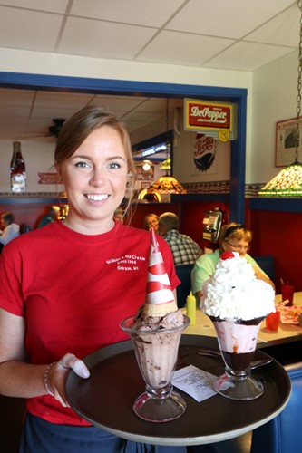 A server holds up a tray of ice cream treats.