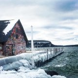 Graffiti-covered building on an ice-covered dock